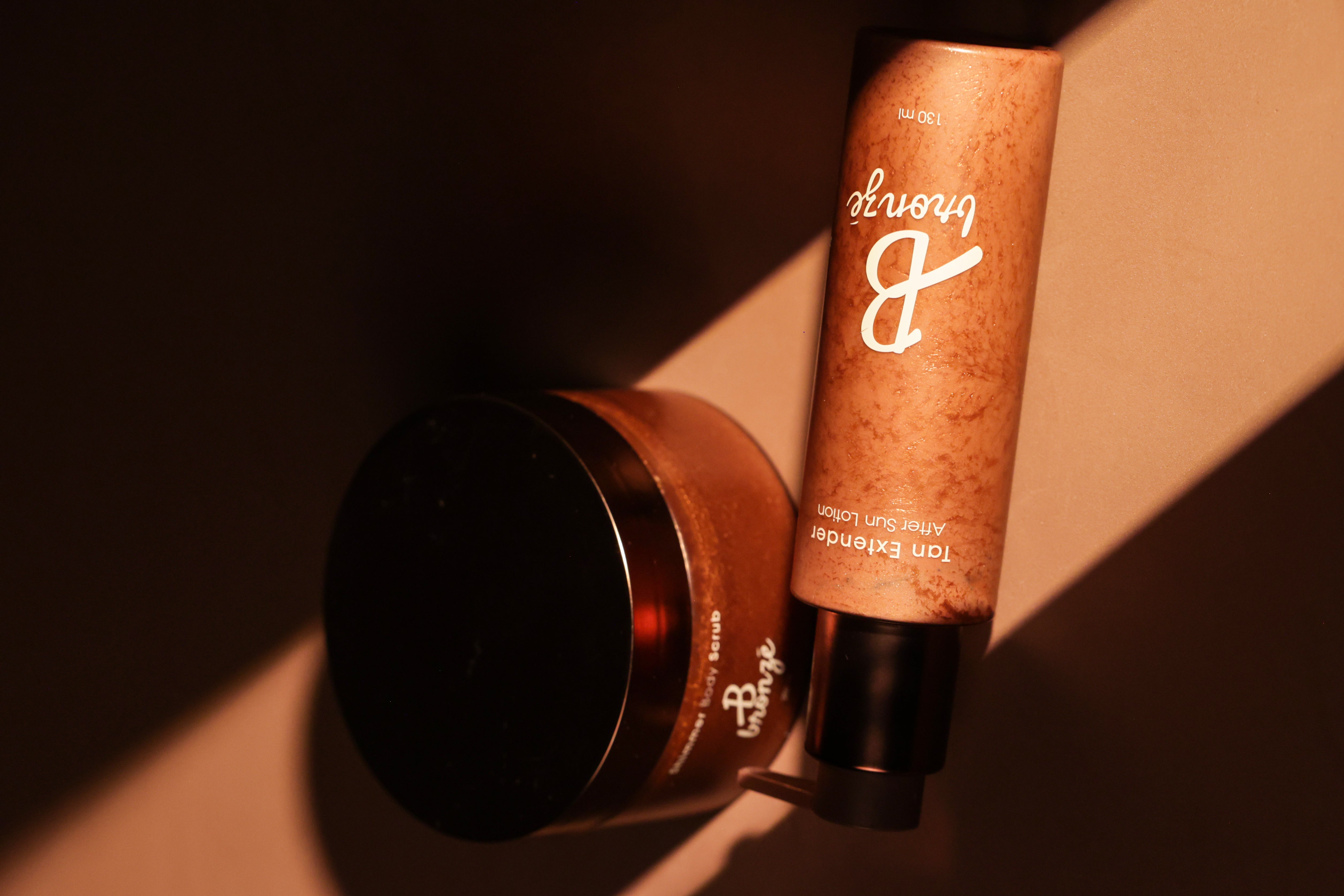 B Bronzé Tan Extender After Sun Lotion and Shimmer Body Scrub in warm sunlight