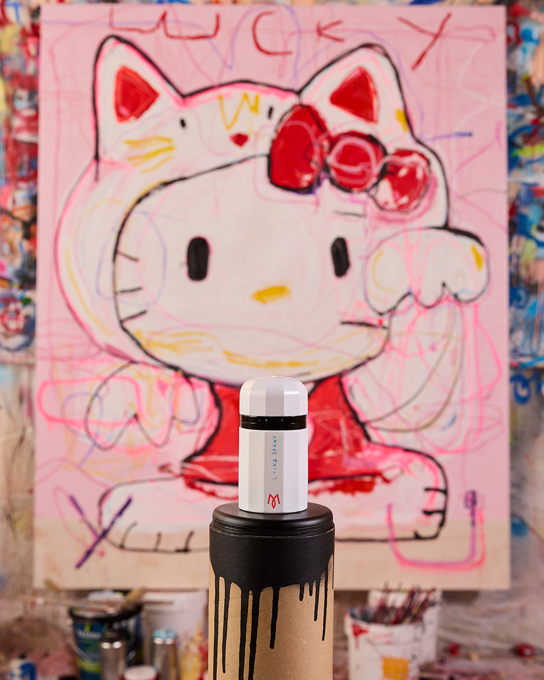 Lucky Spray bottle in Miguel Caravaca's studio in front of the lucky cat painting